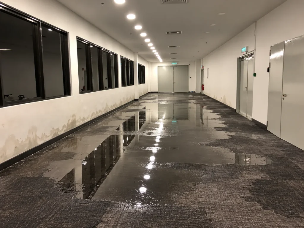 Office water damage repair with air movers between desks